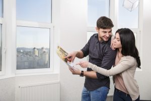 A couple using a custom book to see a house listing