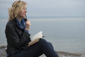 Poet by the sea with a journal